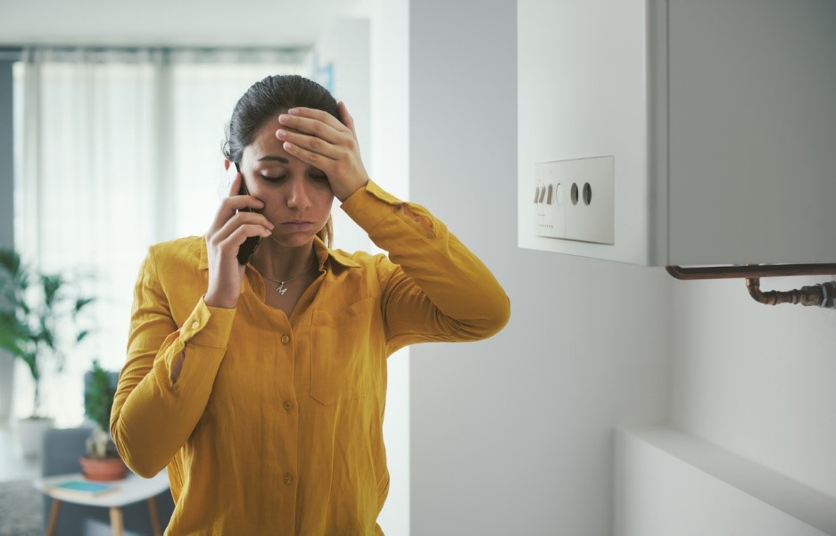 pet poison emergency, A person holding her head and talking on the phone